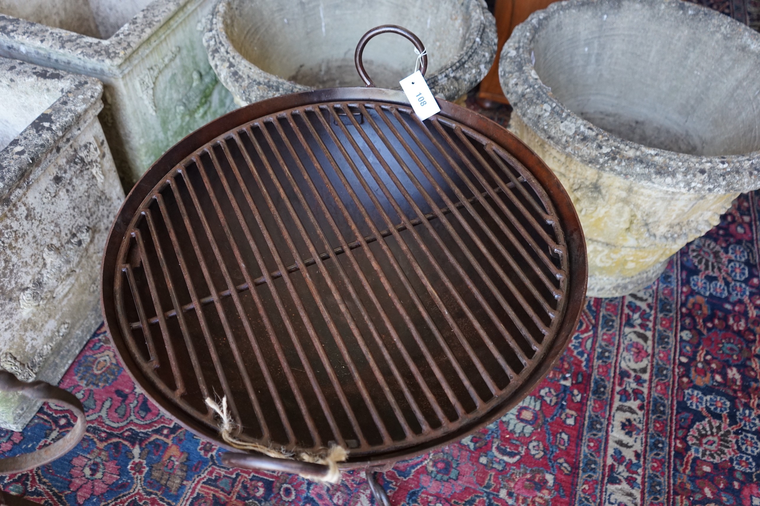 A wrought and cast iron fire pit on stand, diameter 62cm, height 65cm